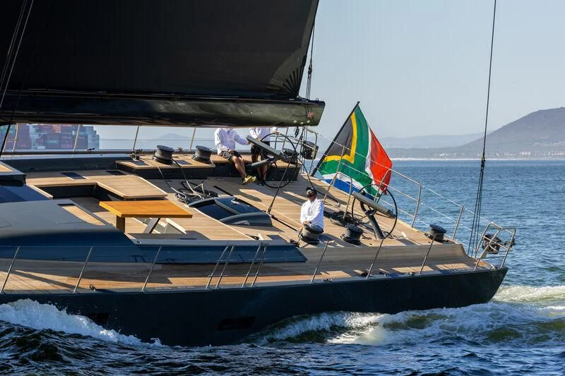 a boat with a flag on the front aboard NYUMBA GT Yacht for Sale