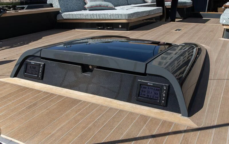 a black rectangular object on a wooden surface aboard NYUMBA GT Yacht for Sale