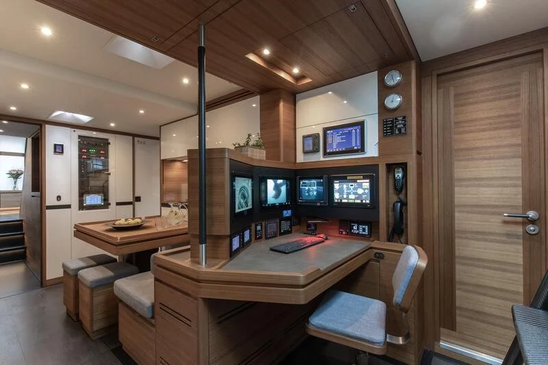 a room with a desk and chairs aboard NYUMBA GT Yacht for Sale
