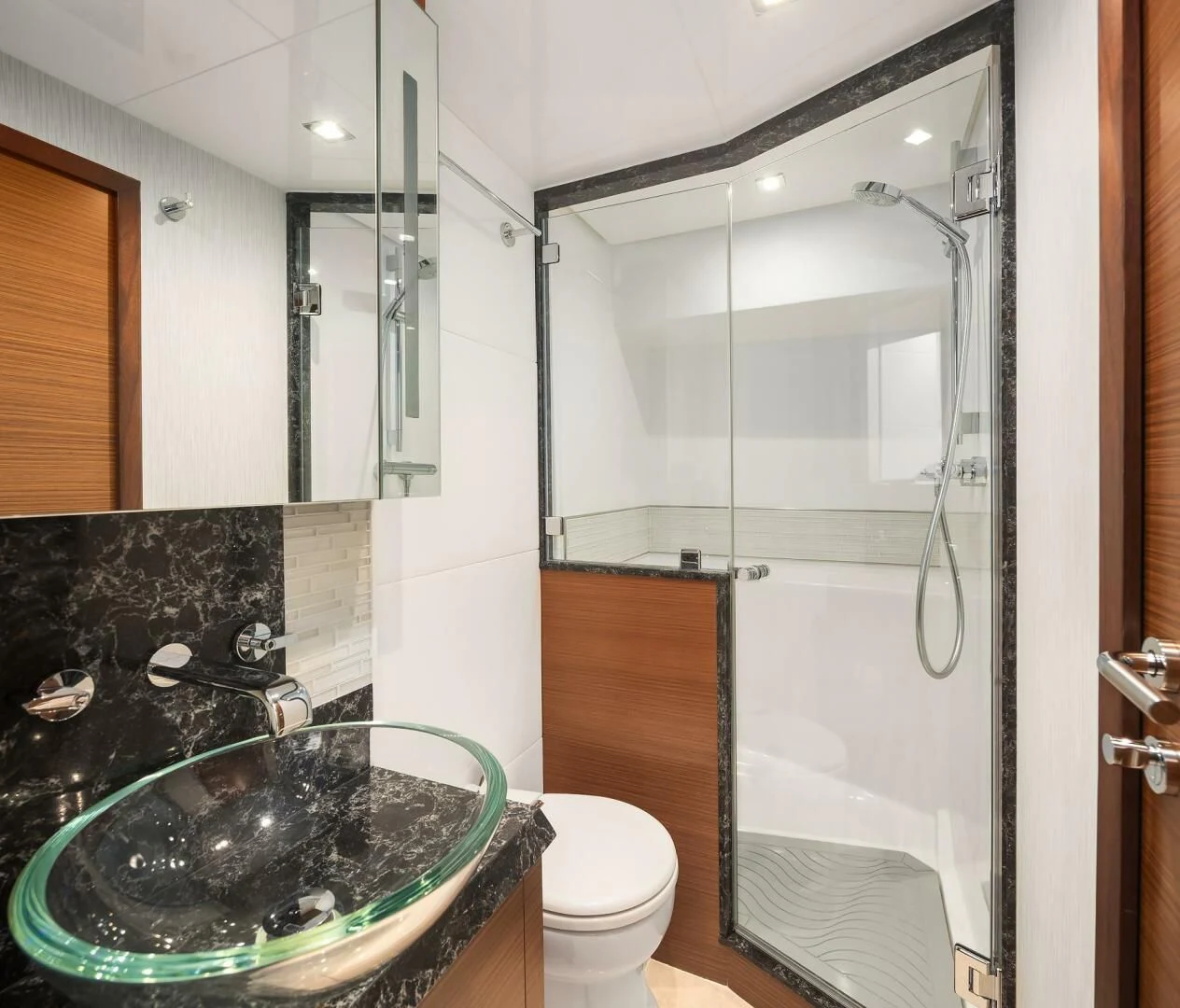 a bathroom with a glass shower aboard PLAYBOOK Yacht for Sale