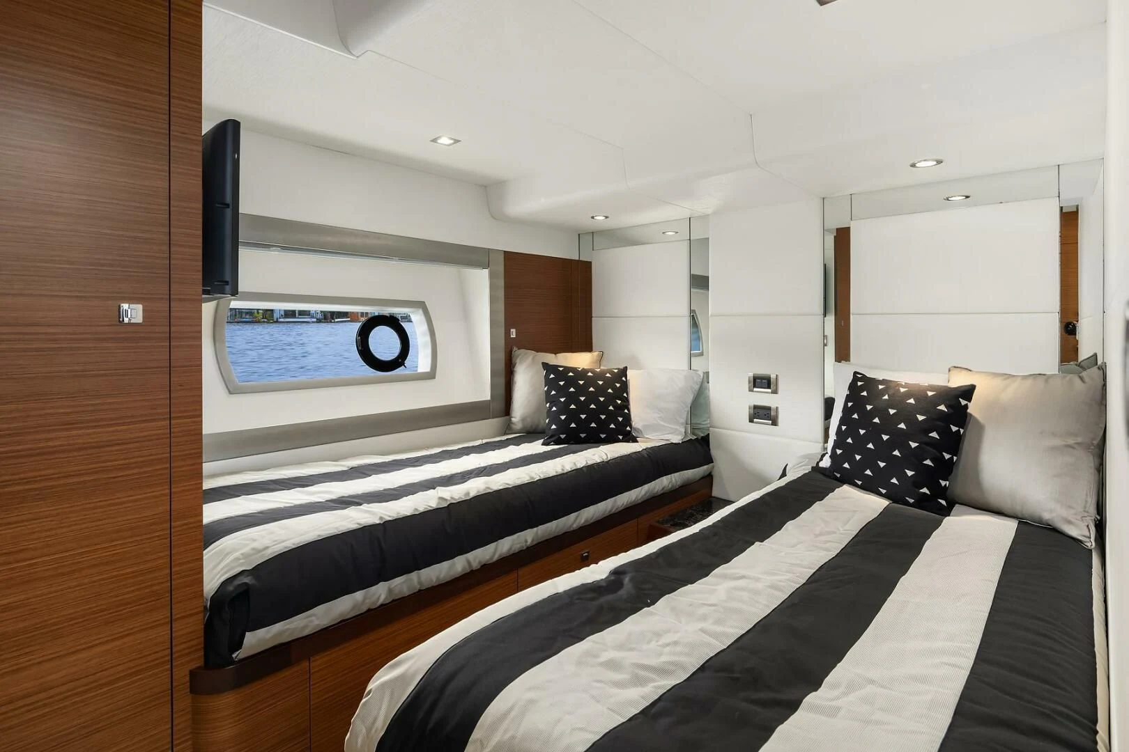 a bedroom with a bed and a television aboard PLAYBOOK Yacht for Sale