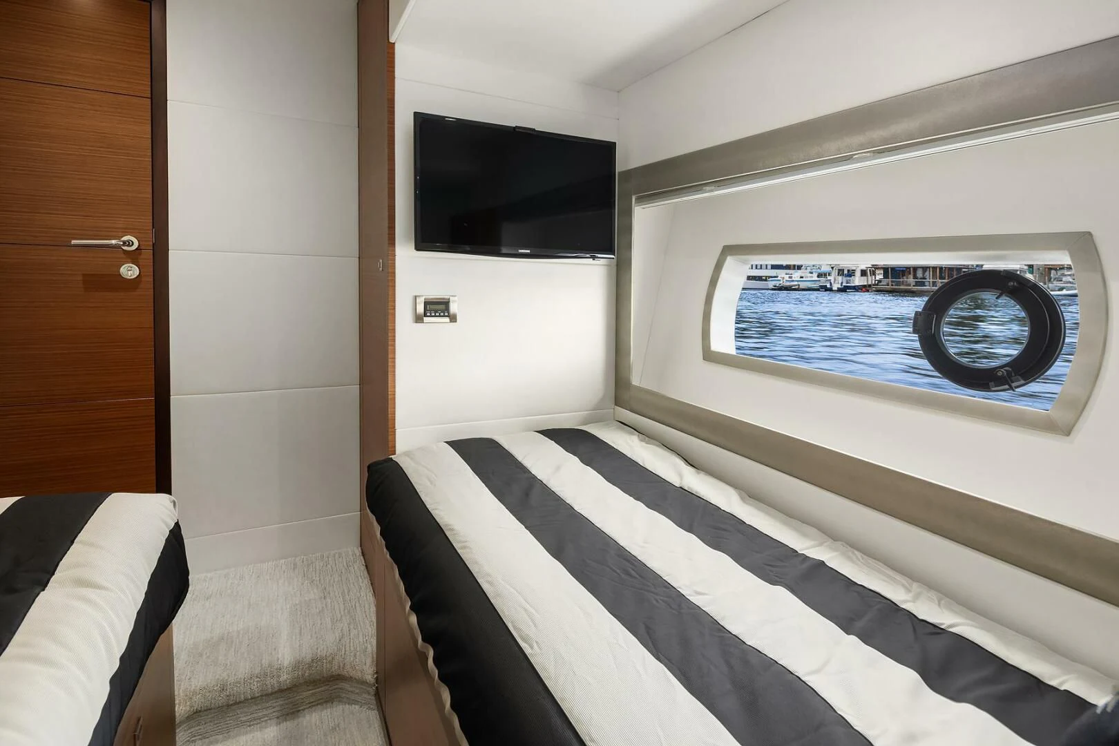 a bed with a picture on the wall aboard PLAYBOOK Yacht for Sale
