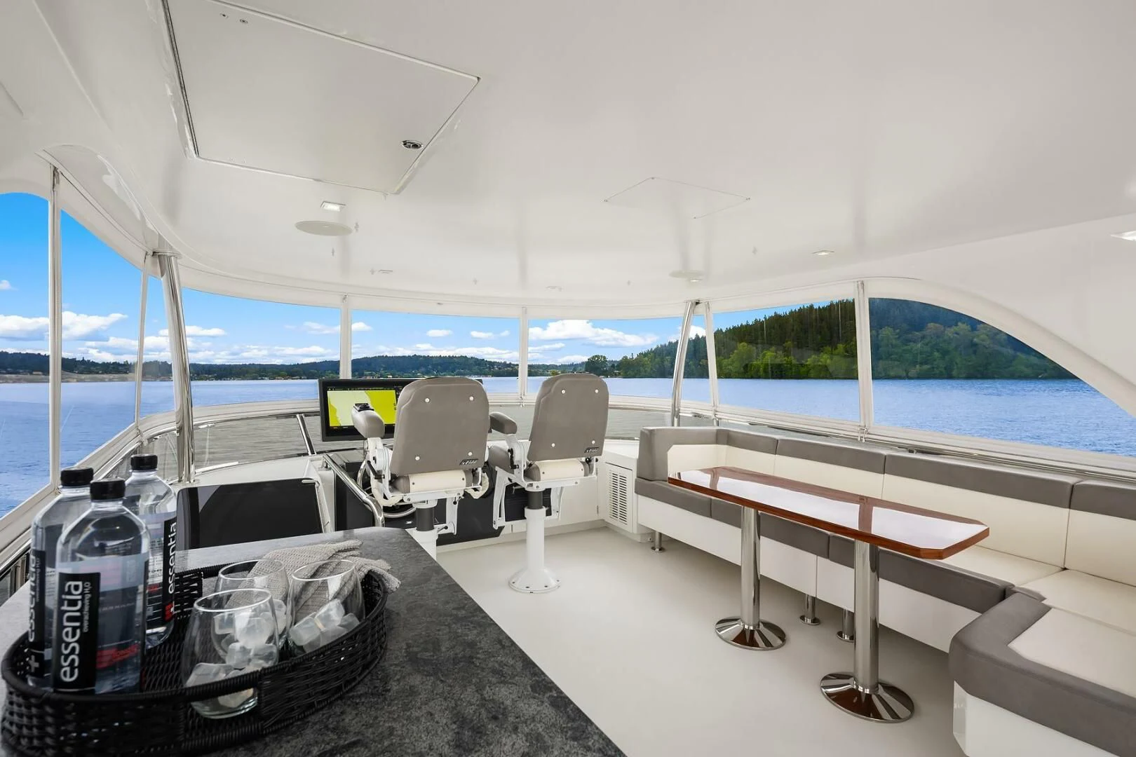 a room with a table and chairs aboard PLAYBOOK Yacht for Sale