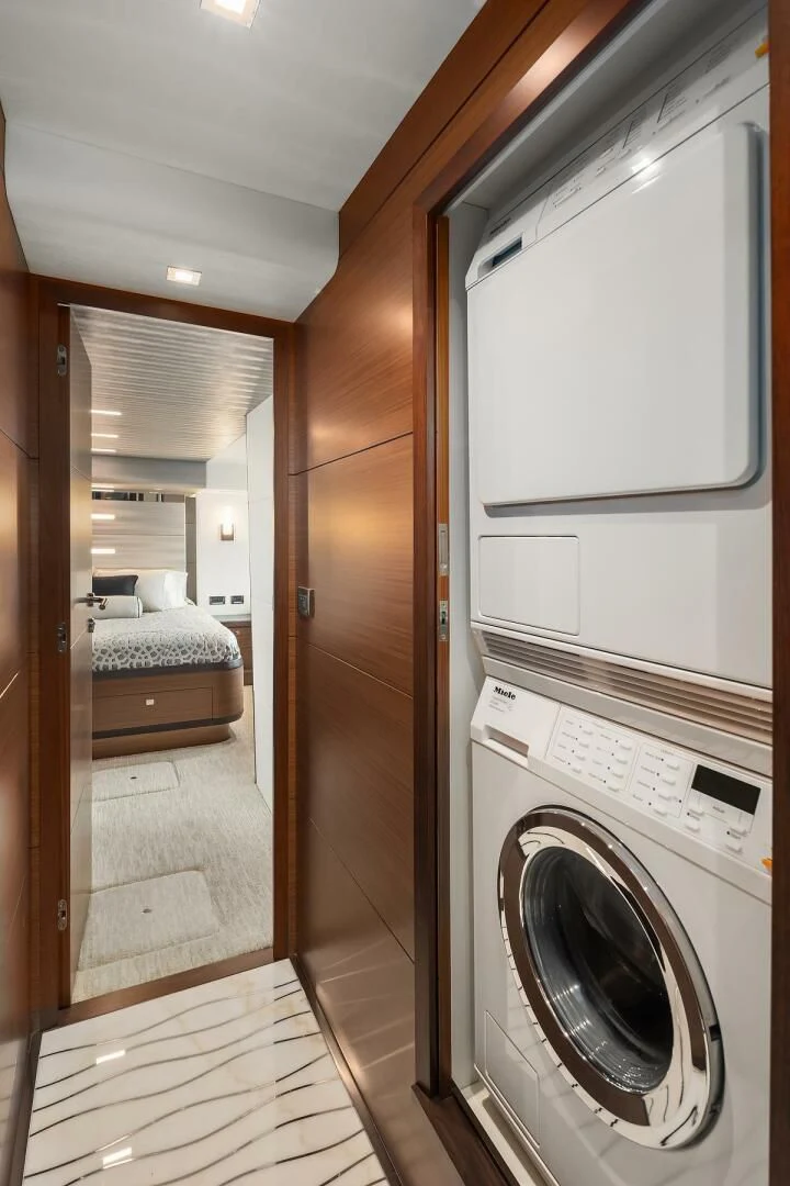 a washer and dryer in a room aboard PLAYBOOK Yacht for Sale