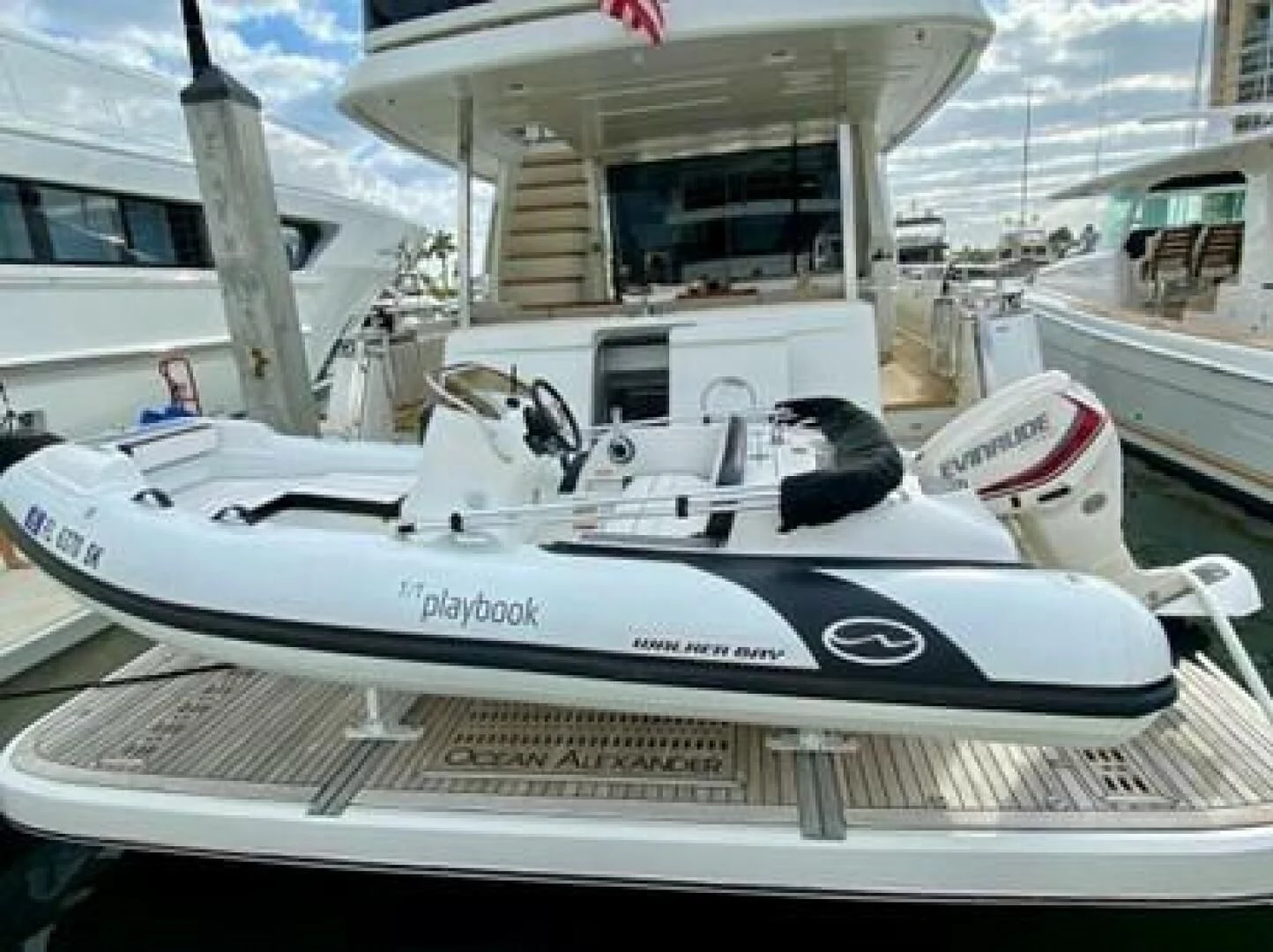 a white boat with a white sail aboard PLAYBOOK Yacht for Sale