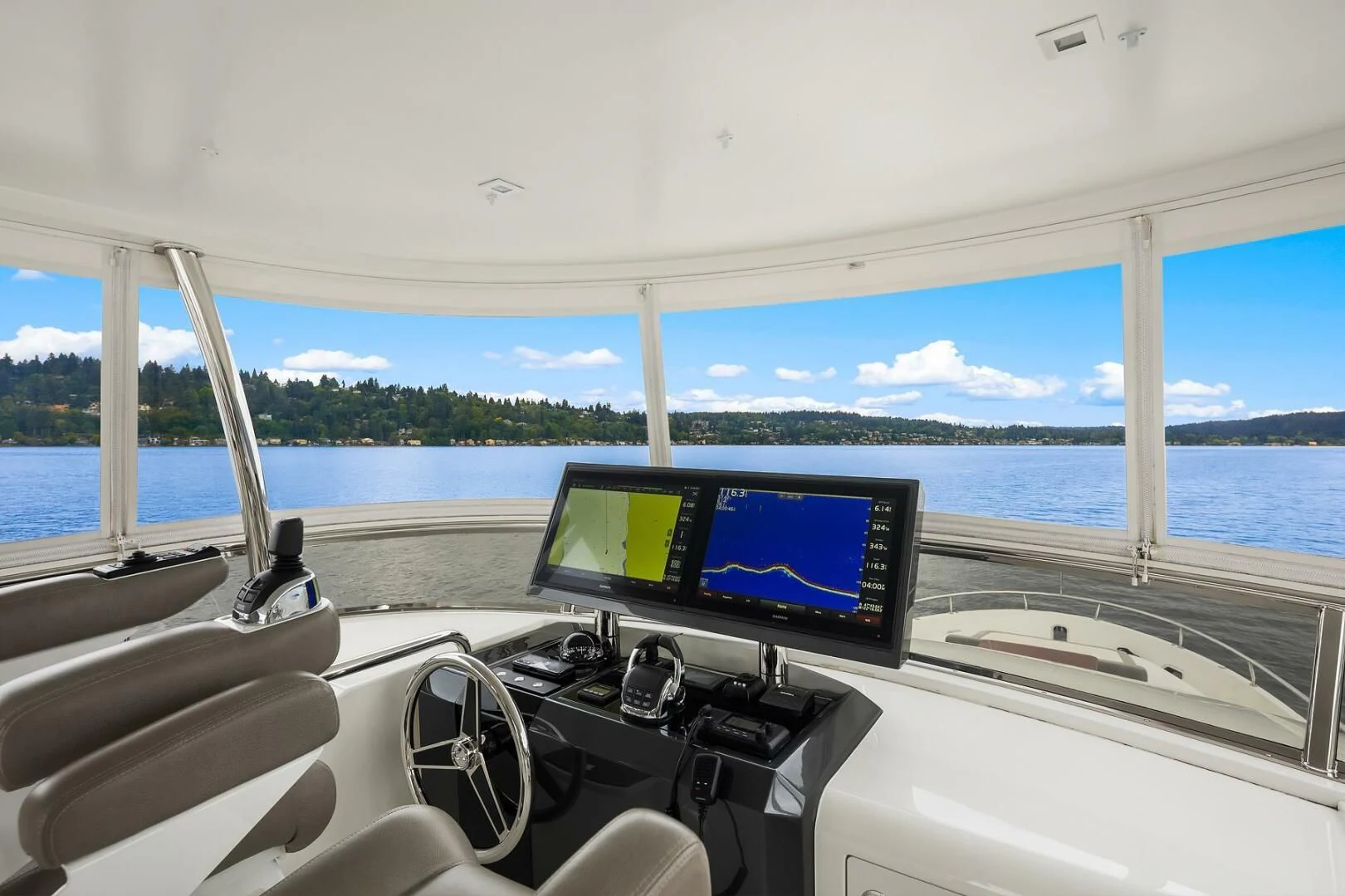 a view of a boat with a computer monitor and a television on the water aboard PLAYBOOK Yacht for Sale
