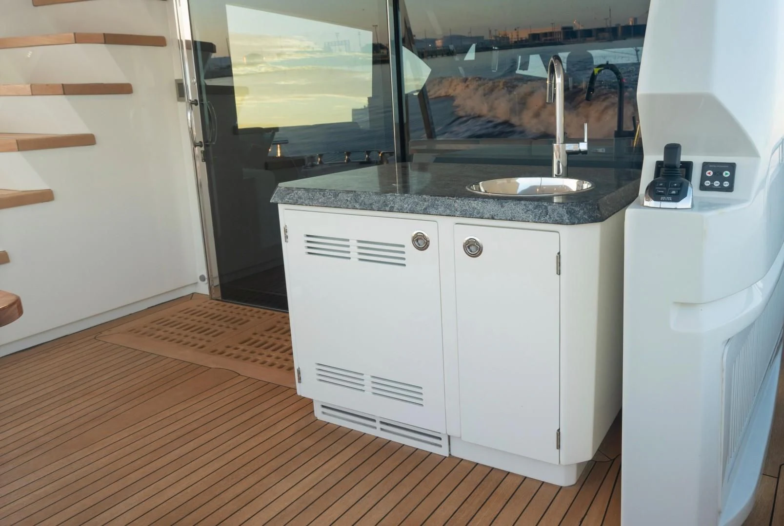 a kitchen with a sink and a refrigerator aboard PLAYBOOK Yacht for Sale