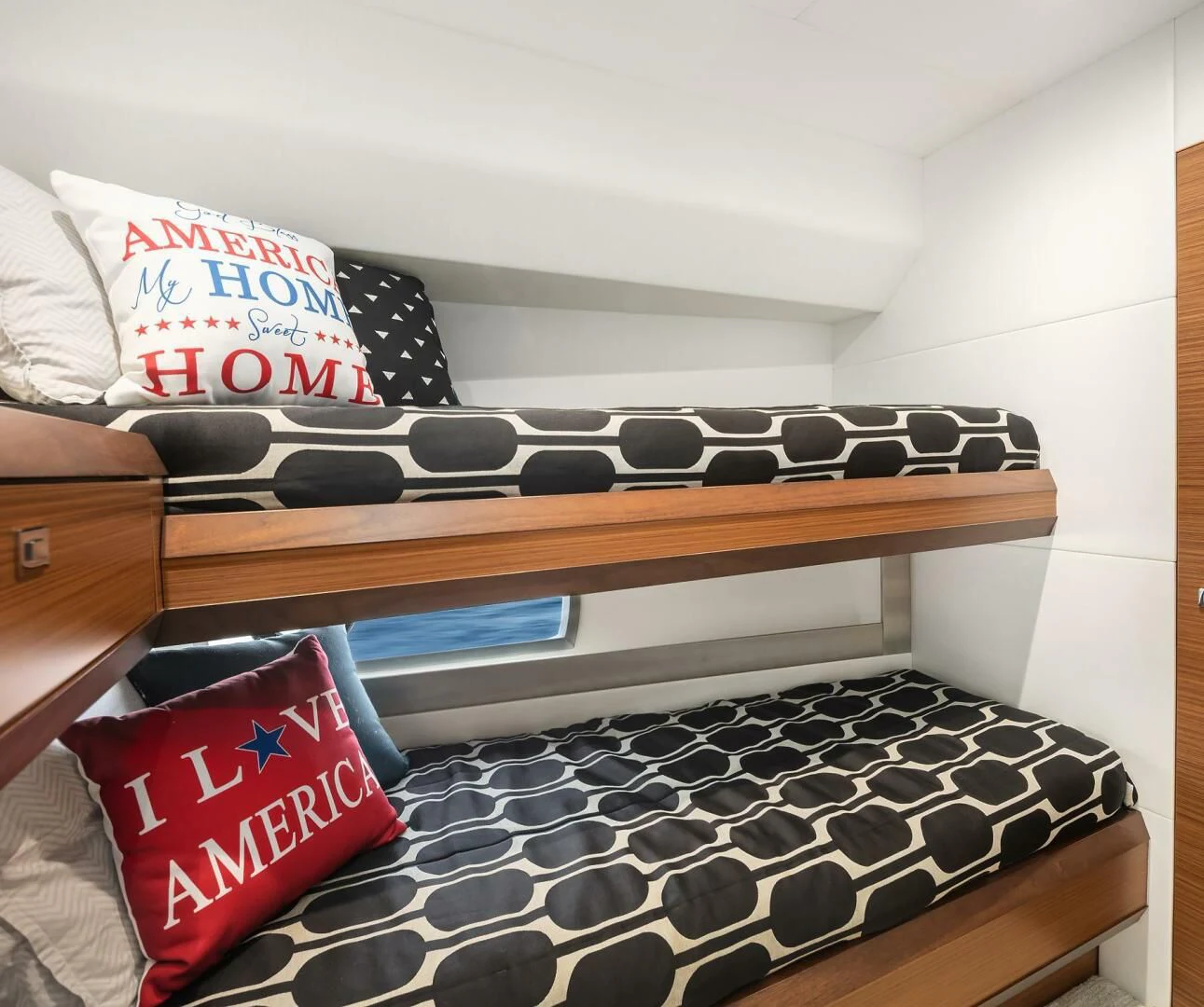 a shelf with a video game console and a red and white pillow aboard PLAYBOOK Yacht for Sale