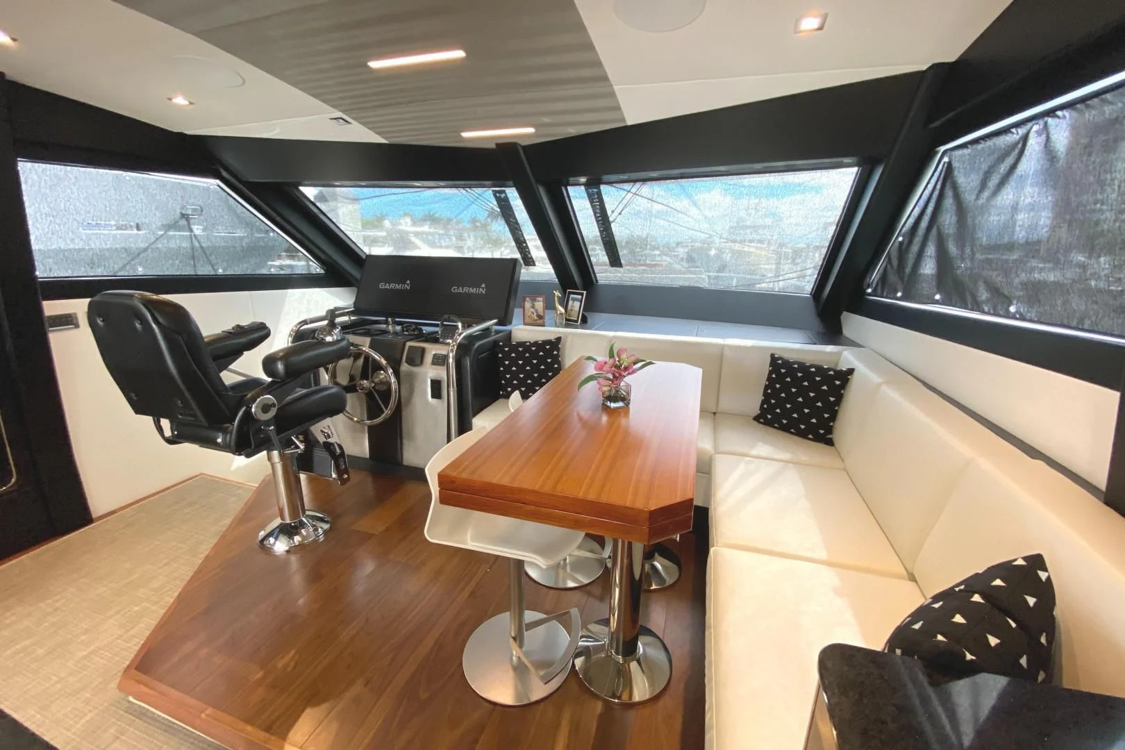 a living room with a table and chairs aboard PLAYBOOK Yacht for Sale