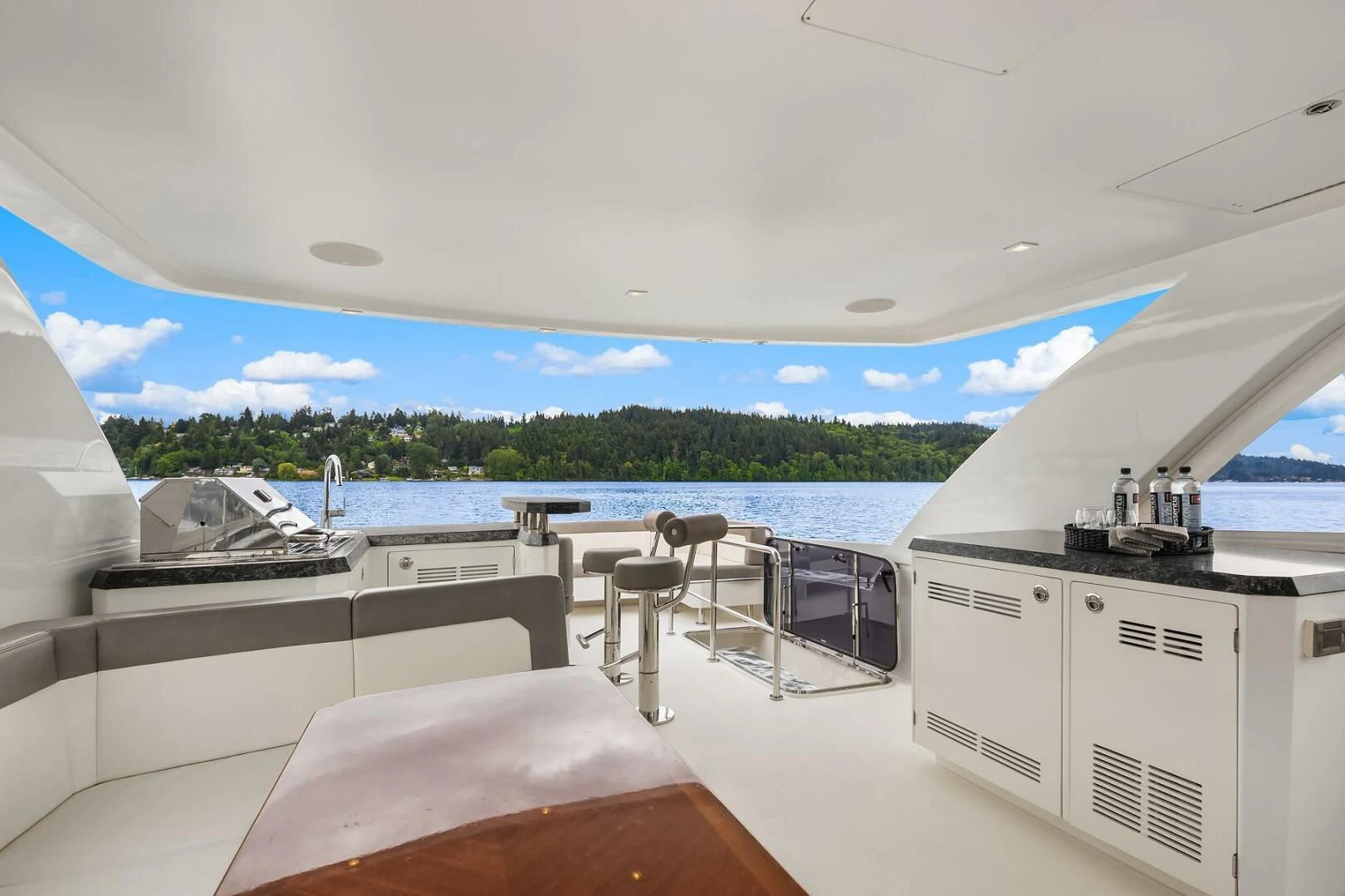 a room with a view of the ocean and a large pool aboard PLAYBOOK Yacht for Sale