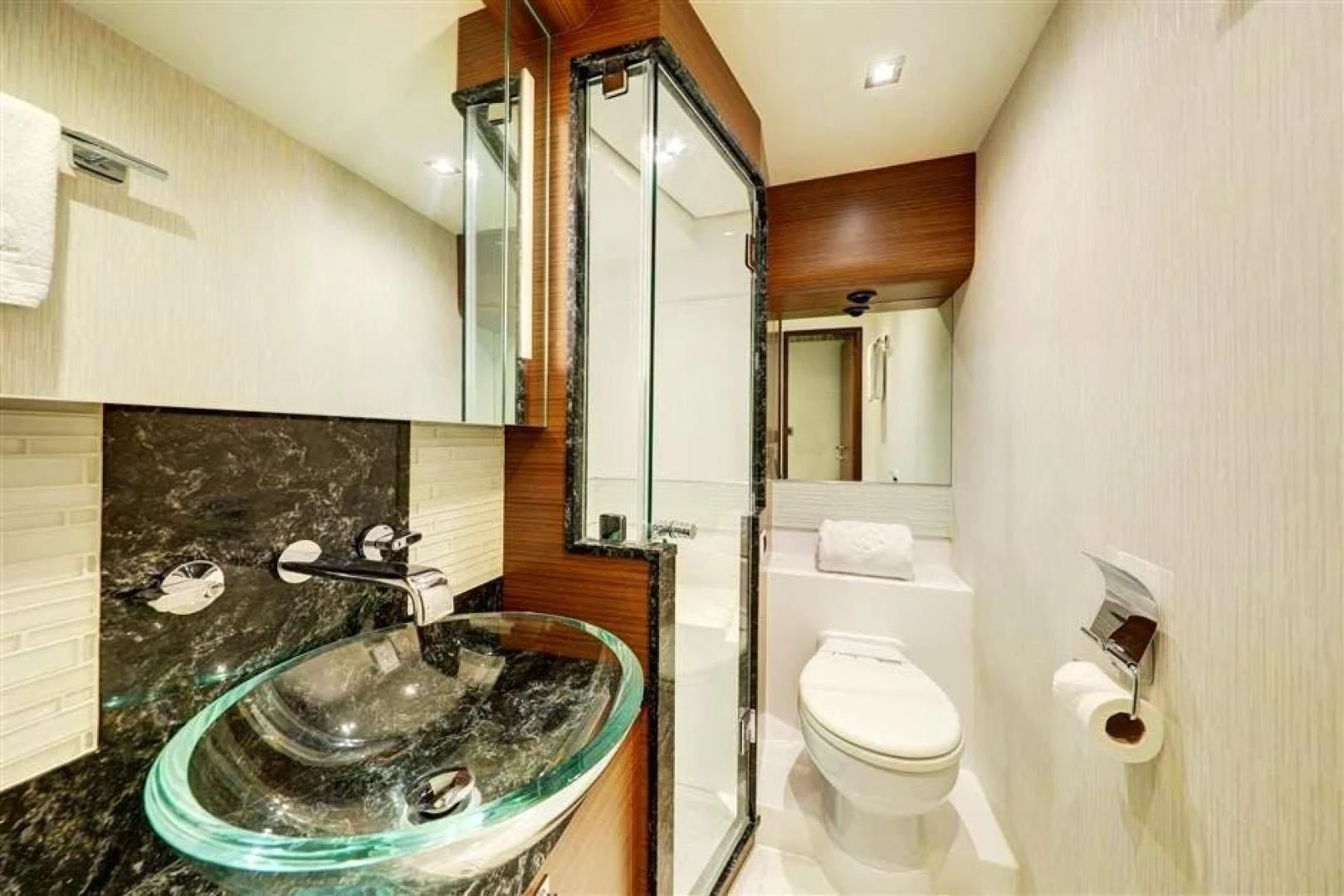 a bathroom with a sink toilet and a mirror aboard PLAYBOOK Yacht for Sale