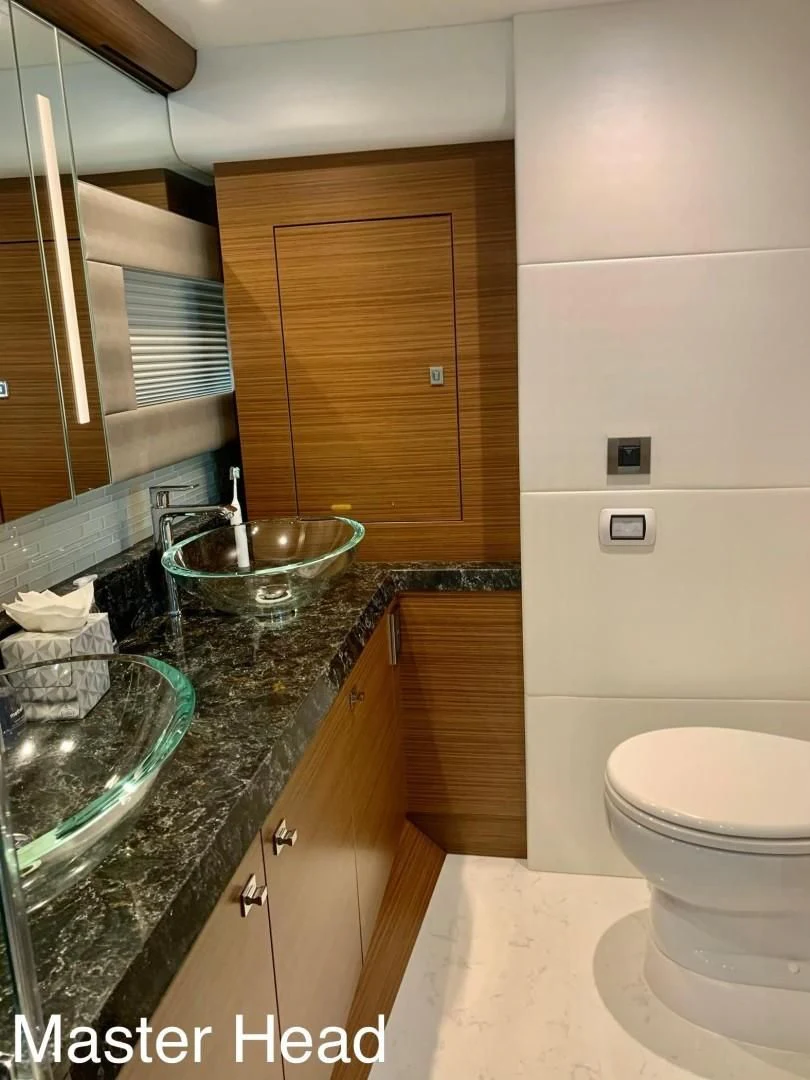 a bathroom with a sink and toilet aboard PLAYBOOK Yacht for Sale