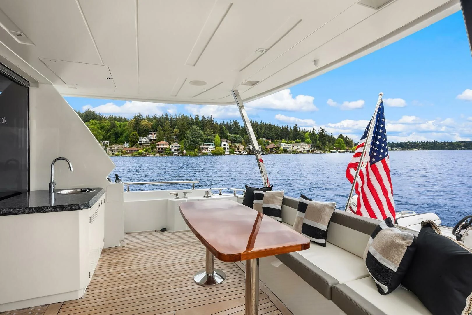 a boat with a flag on it aboard PLAYBOOK Yacht for Sale
