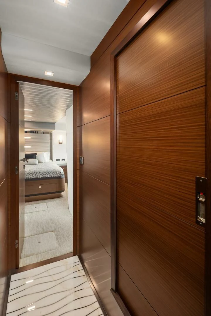 a room with a bed and a mirror aboard PLAYBOOK Yacht for Sale