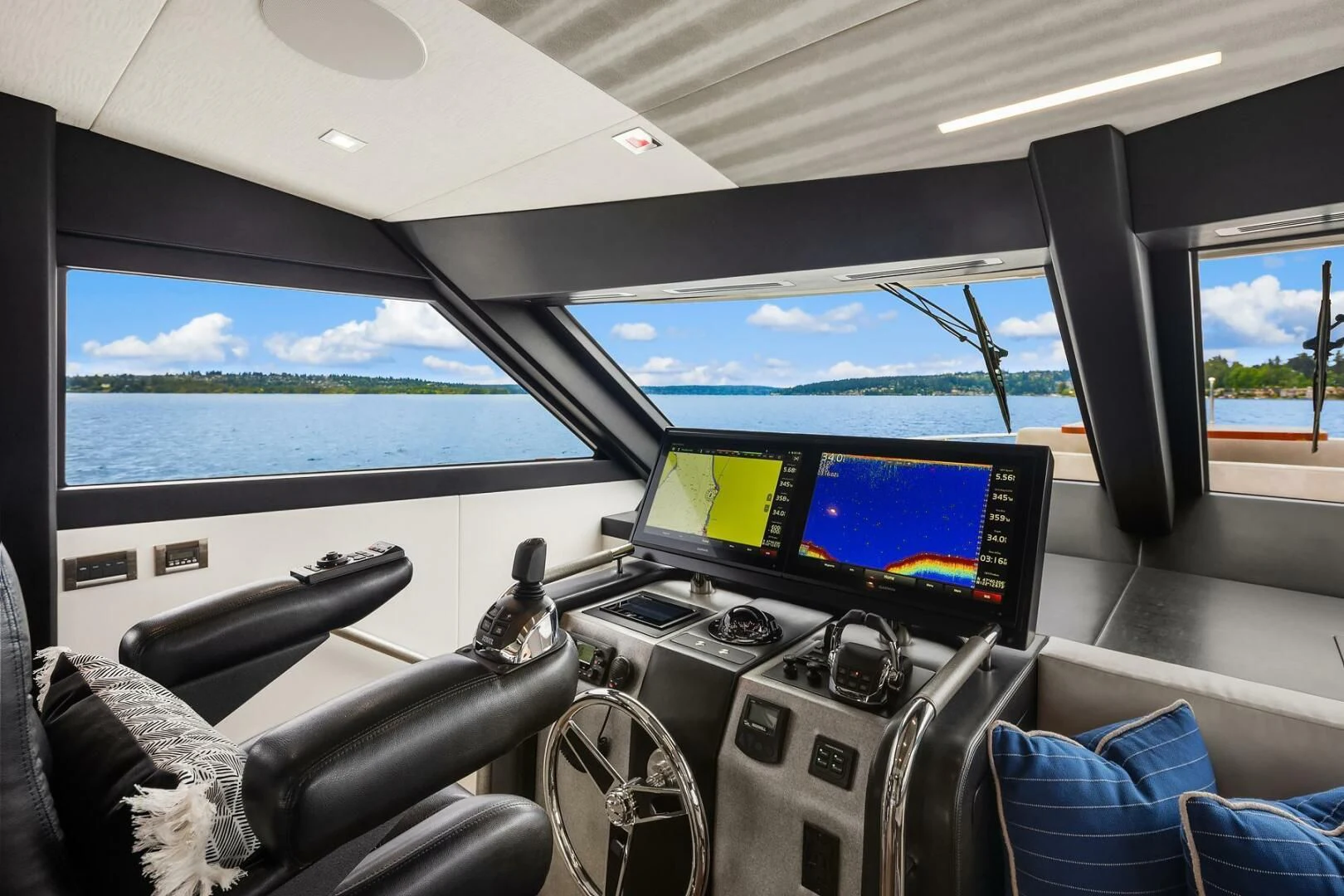 inside of a car with a view of the ocean and the land below aboard PLAYBOOK Yacht for Sale