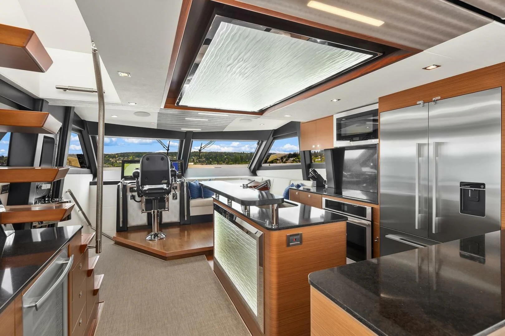 a room with a large window and a table with chairs and a large window aboard PLAYBOOK Yacht for Sale