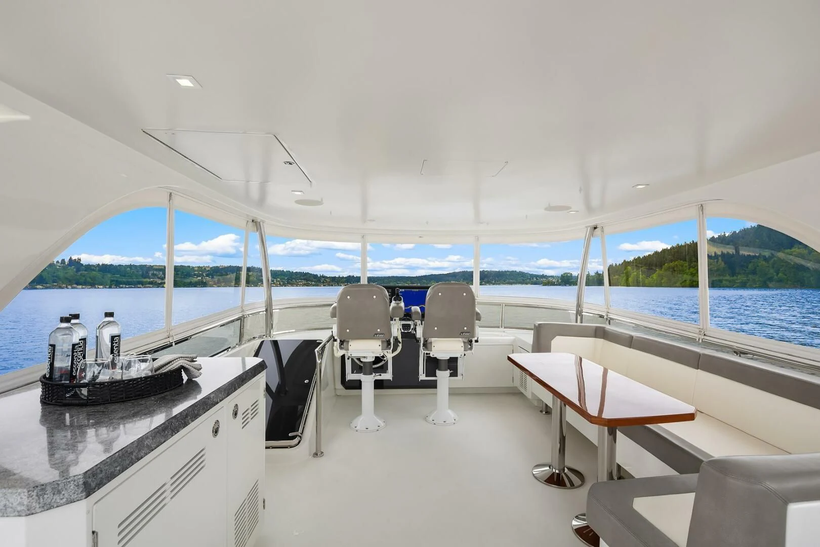 a room with a table chairs and a large window aboard PLAYBOOK Yacht for Sale