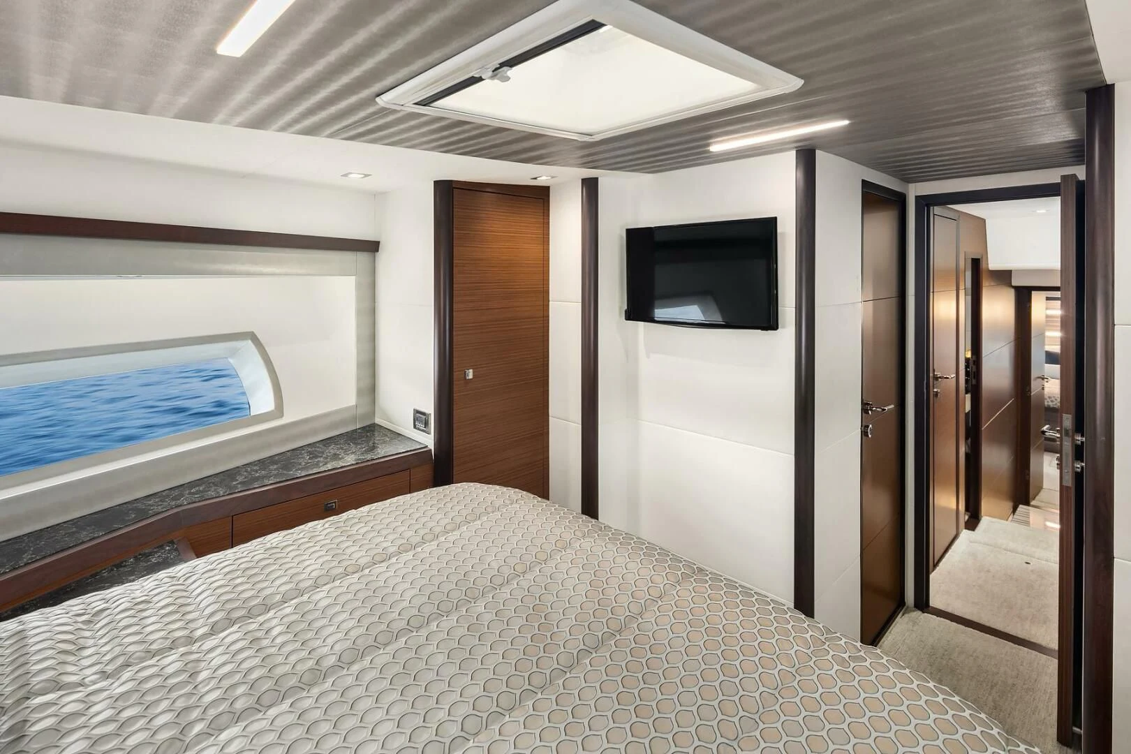 a bedroom with a bed and a television aboard PLAYBOOK Yacht for Sale