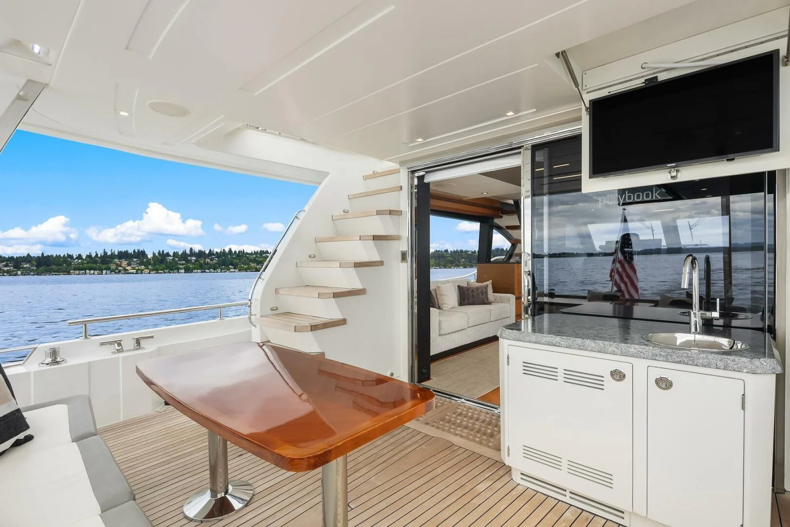 a modern looking kitchen with a large balcony aboard PLAYBOOK Yacht for Sale