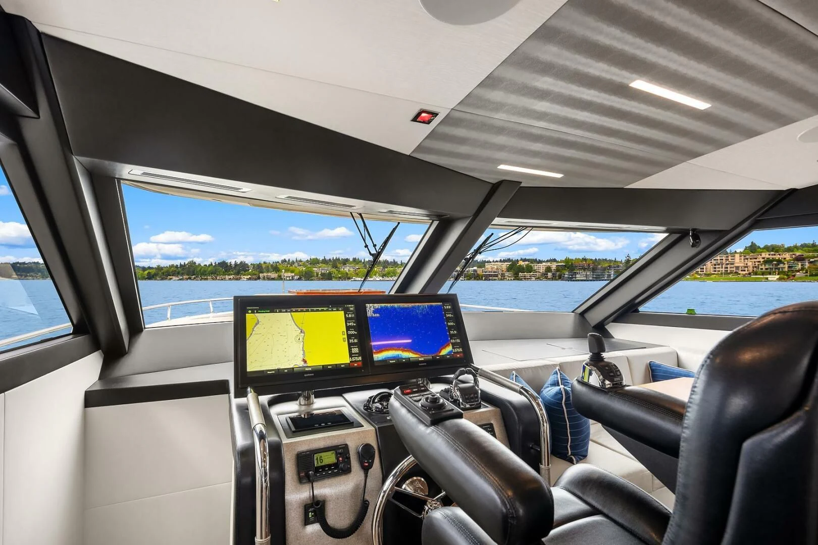 inside of a car with a screen and a monitor on the dashboard aboard PLAYBOOK Yacht for Sale