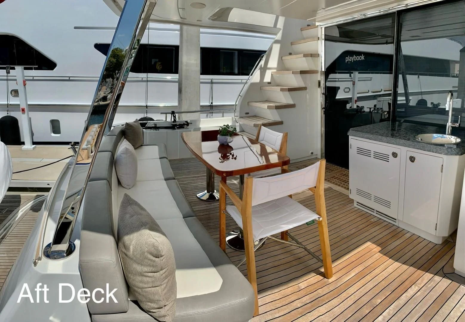 a room with a table and a chair aboard PLAYBOOK Yacht for Sale