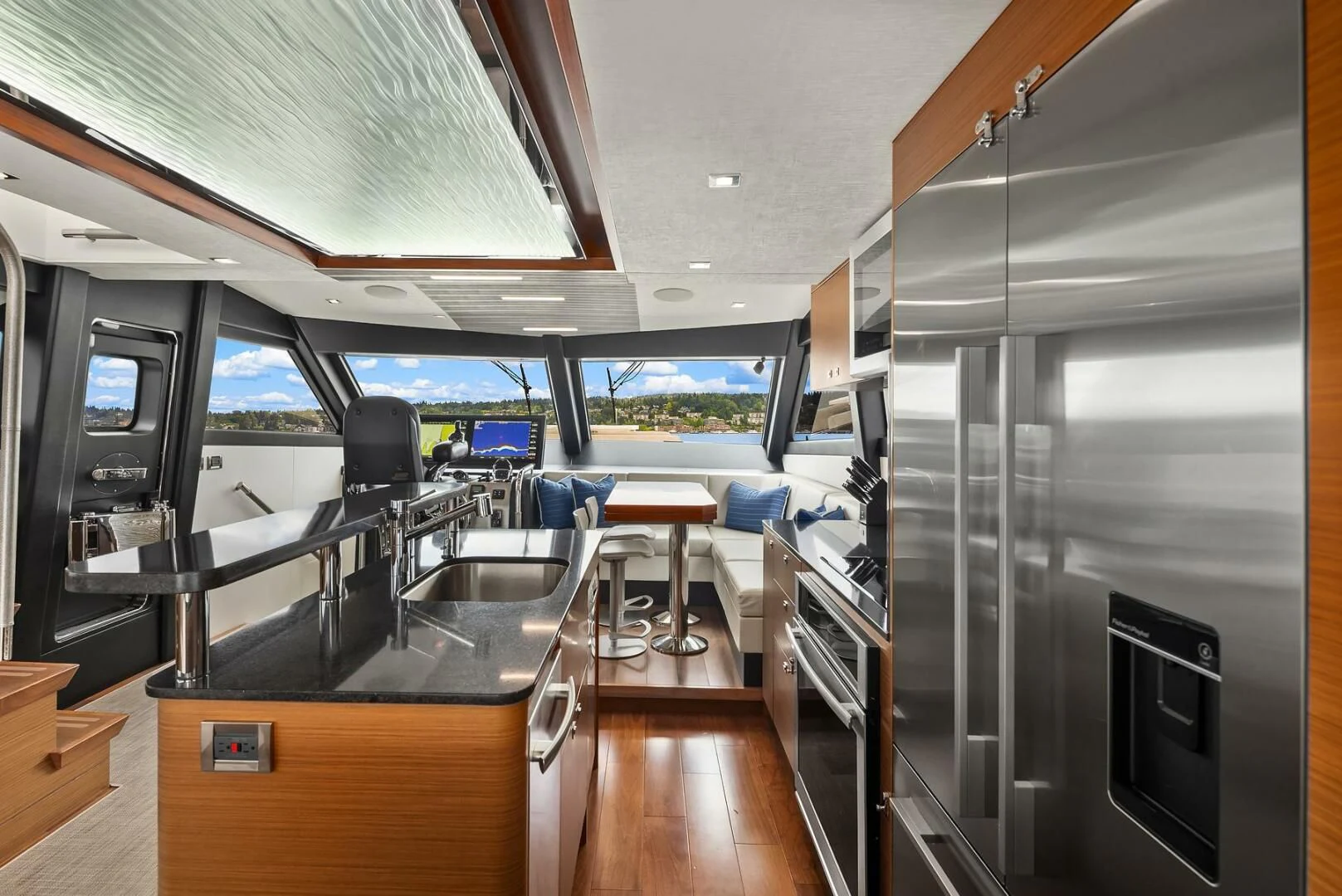 inside of a building with a large glass door and a wood floor aboard PLAYBOOK Yacht for Sale