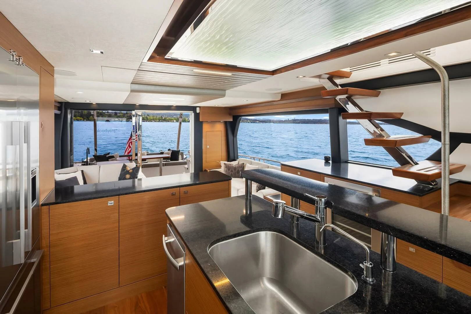 a kitchen with a sink and a large window aboard PLAYBOOK Yacht for Sale