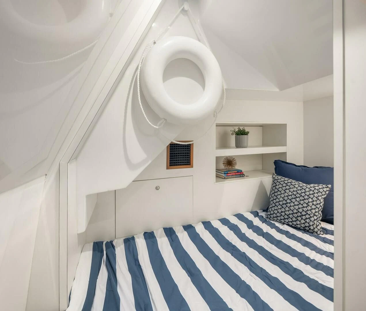 a white bathroom with a blue and white striped floor aboard PLAYBOOK Yacht for Sale