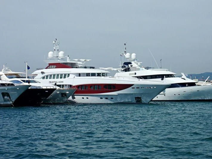 a few large white yachts in the water aboard IDEFIX II Yacht for Charter