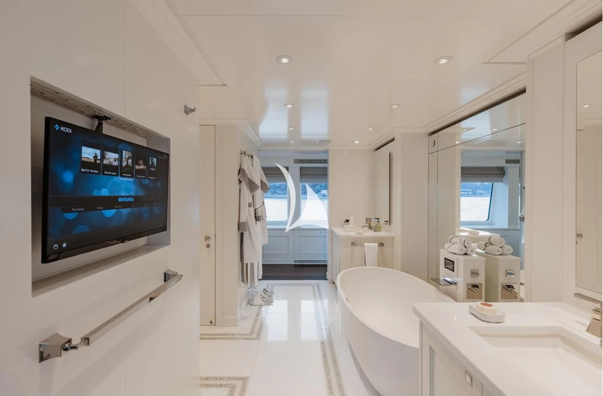 a room with a tv and bathtub aboard IDEFIX II Yacht for Charter