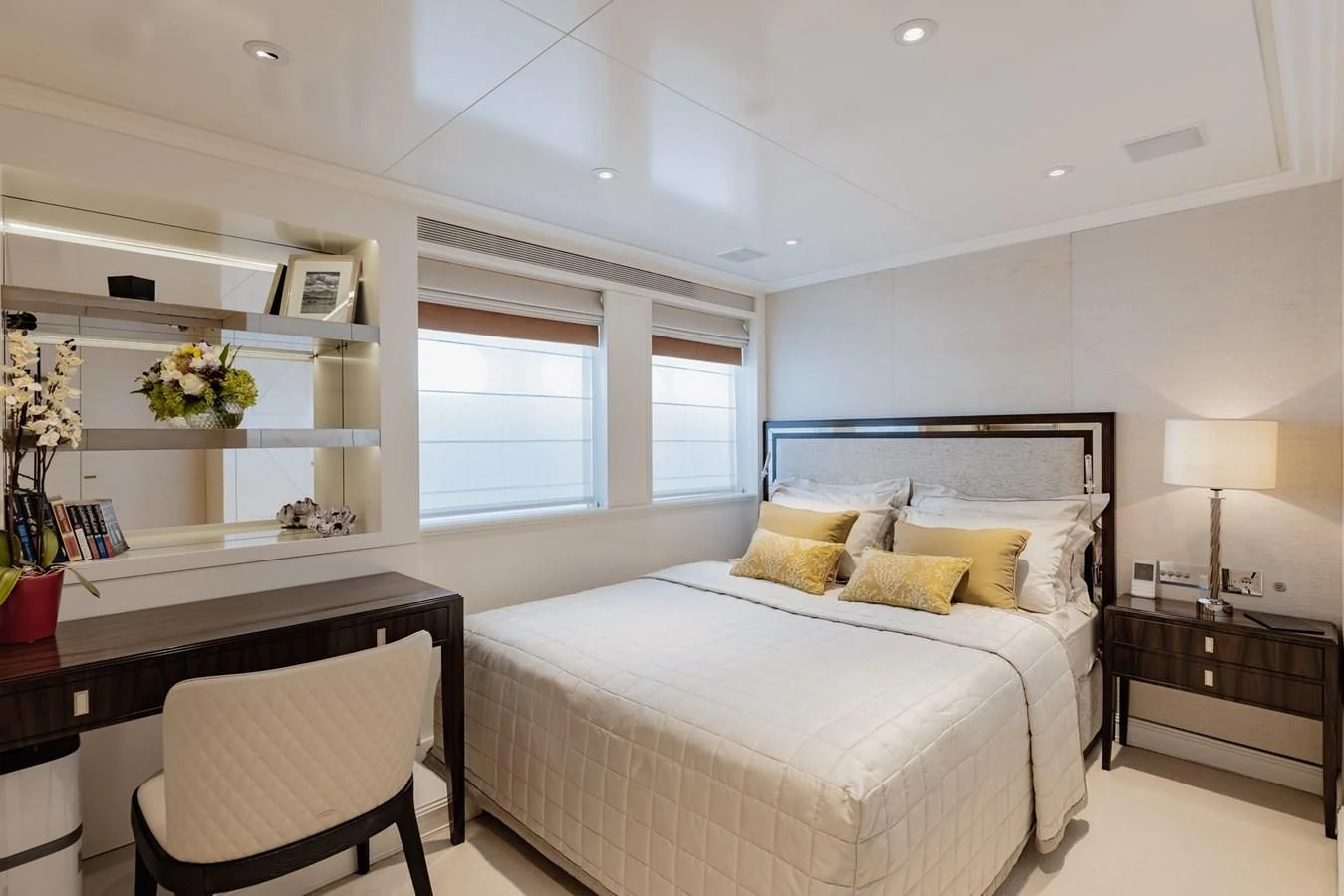 a bedroom with a bed and a desk aboard IDEFIX II Yacht for Charter