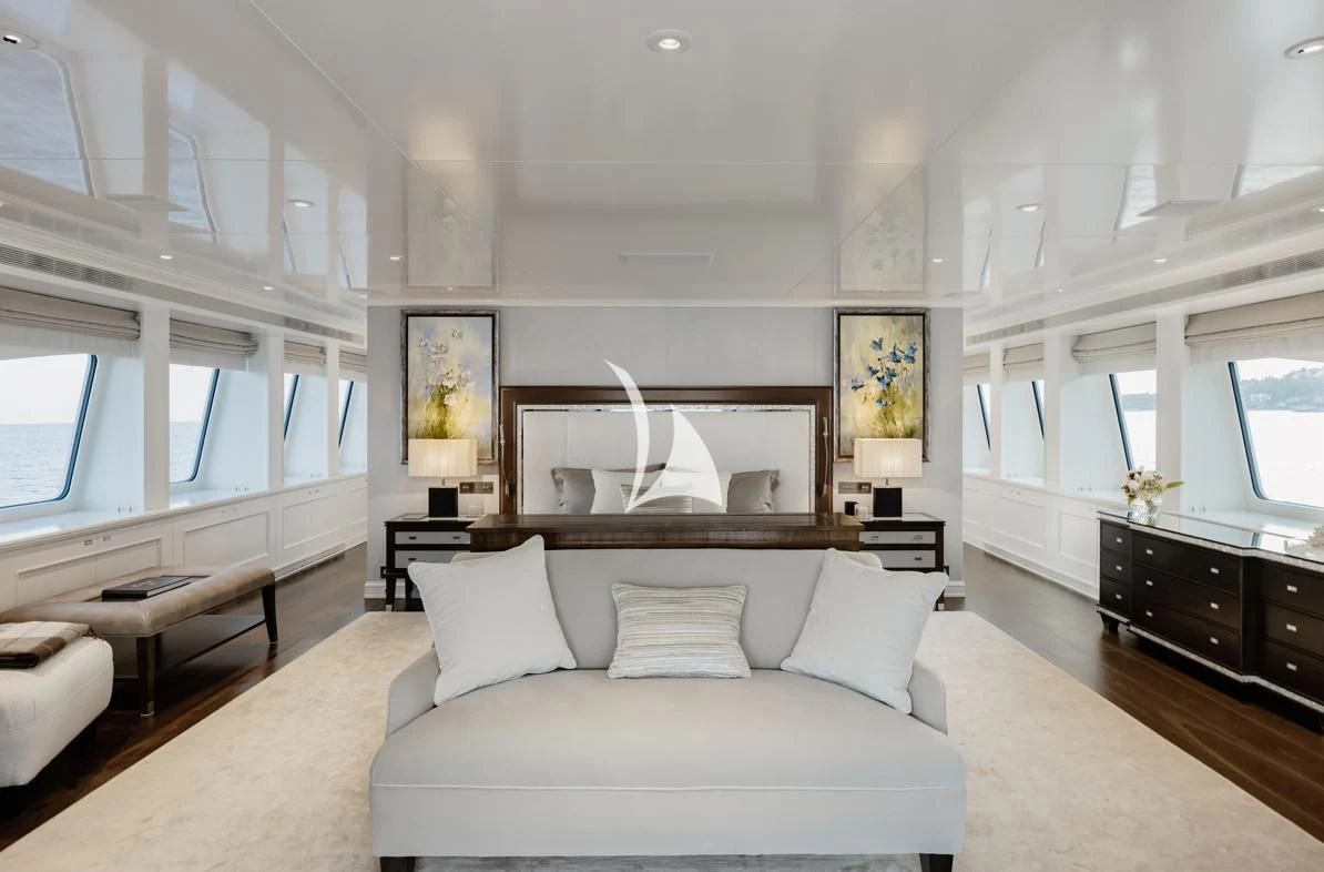 a large white living room with a fireplace aboard IDEFIX II Yacht for Charter