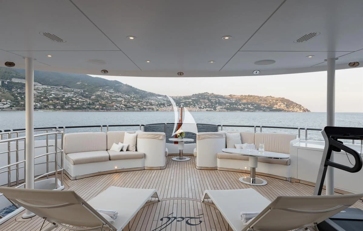 a room with a table chairs and a view of a city aboard IDEFIX II Yacht for Charter