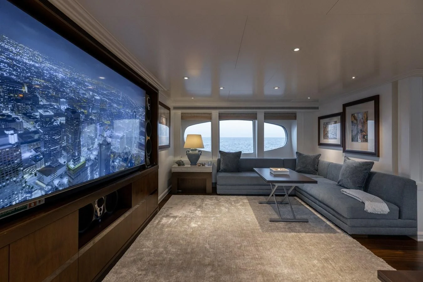 a living room with a large screen aboard IDEFIX II Yacht for Charter