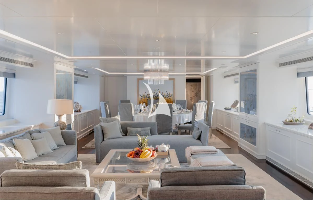 a living room with a blue couch and a white wall aboard IDEFIX II Yacht for Charter