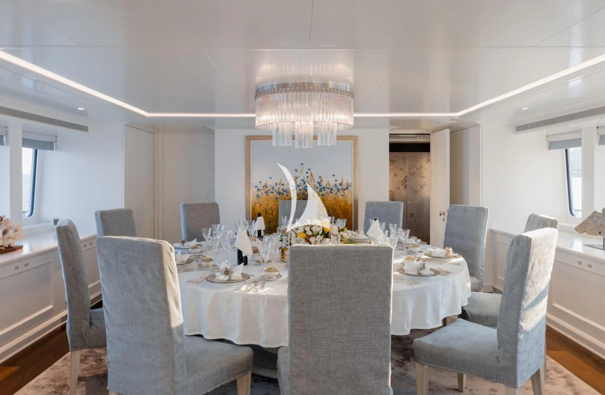 a dining room with a large table and chairs aboard IDEFIX II Yacht for Charter
