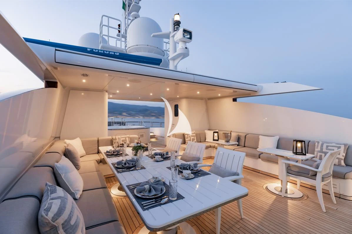 a modern living room with a large white table and a large white sofa aboard IDEFIX II Yacht for Charter