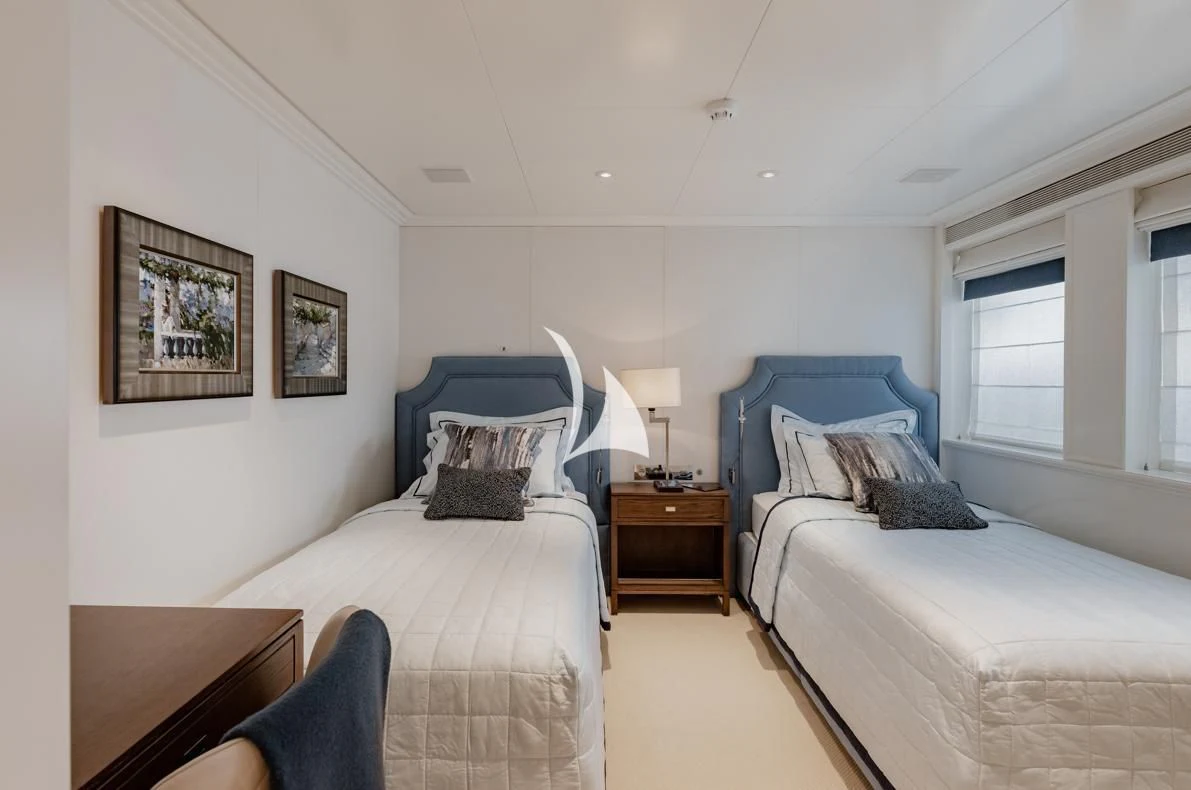 a bedroom with two beds aboard IDEFIX II Yacht for Charter