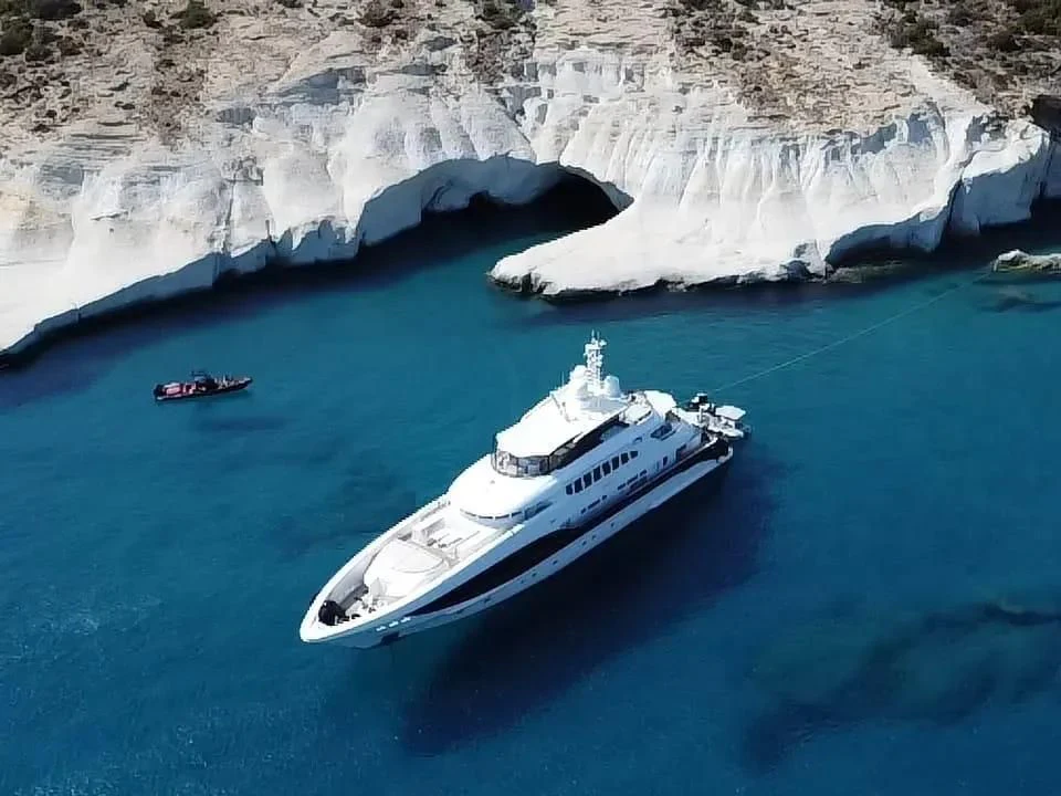 a whale and a boat in the water aboard IDEFIX II Yacht for Charter
