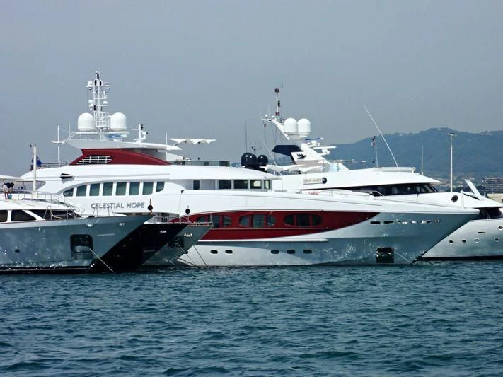 a couple of large white boats in the water aboard IDEFIX II Yacht for Charter