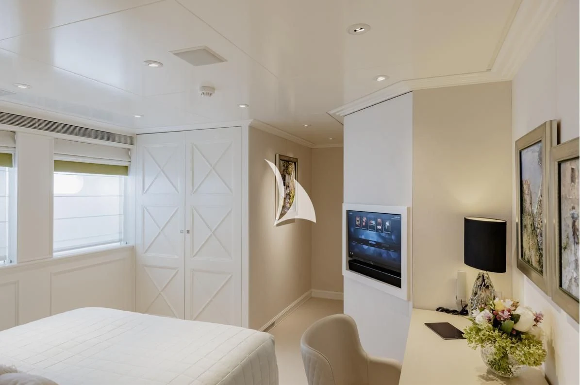 a bedroom with a bed and a tv aboard IDEFIX II Yacht for Charter