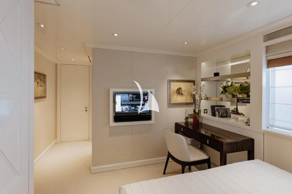 a room with a desk and a tv aboard IDEFIX II Yacht for Charter