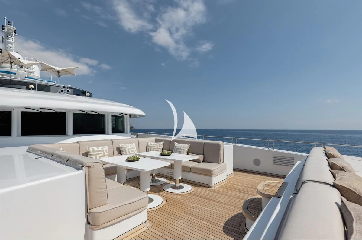 a room with a table chairs and a large body of water aboard IDEFIX II Yacht for Charter