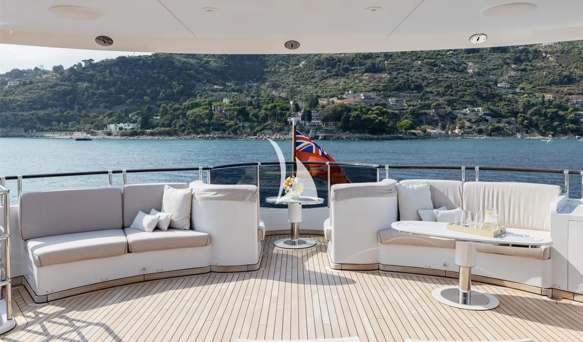 a room with a couch and a table and a large body of water aboard IDEFIX II Yacht for Charter