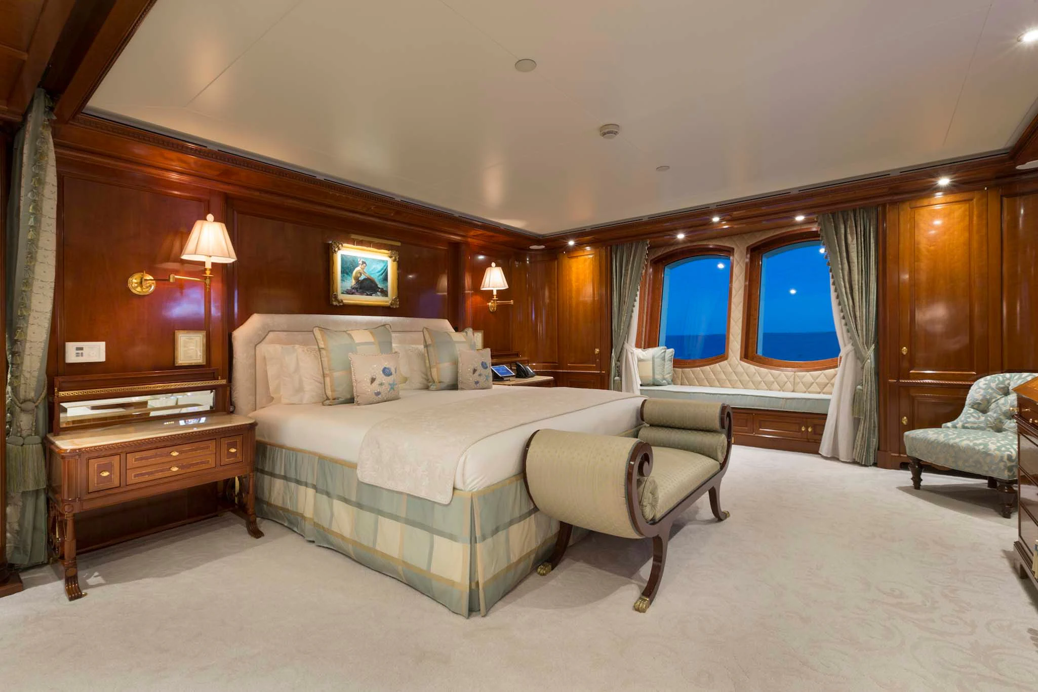 a large bedroom with a bed and a chair aboard KATHARINE Yacht for Sale