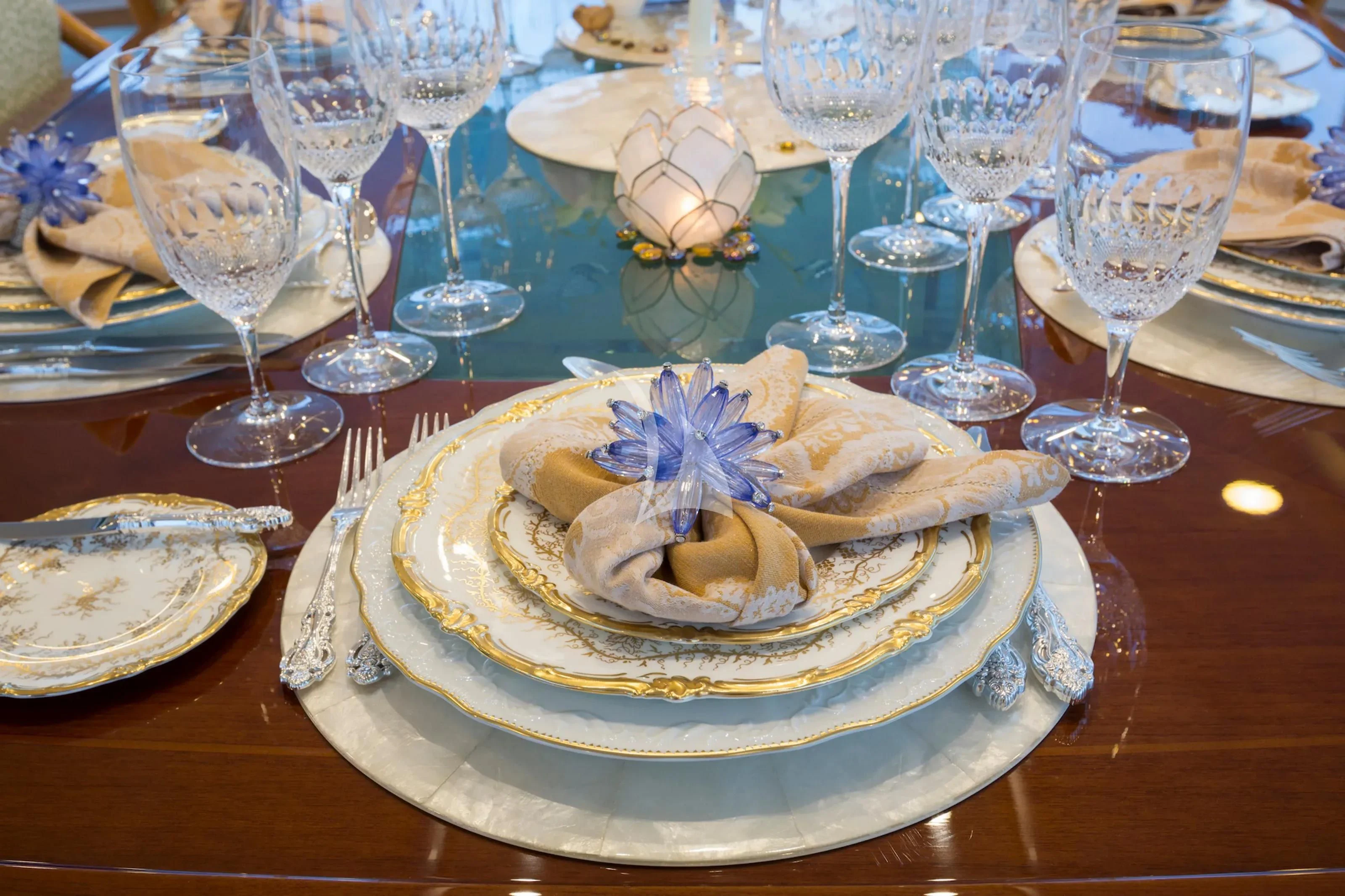 a table with plates and glasses of wine aboard KATHARINE Yacht for Sale