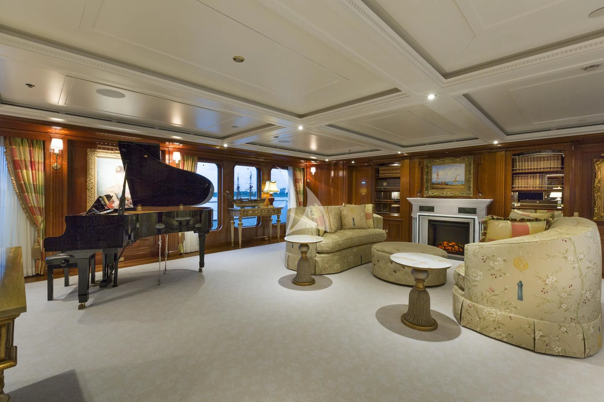 a living room with a piano and a table aboard KATHARINE Yacht for Sale