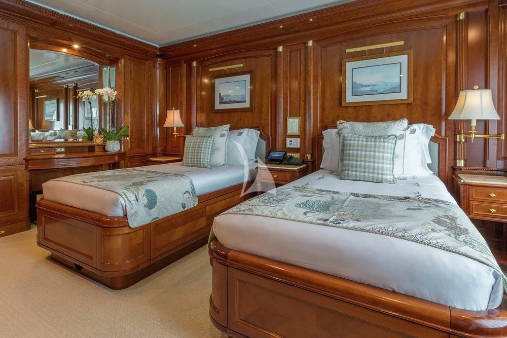 a bedroom with two beds aboard KATHARINE Yacht for Sale