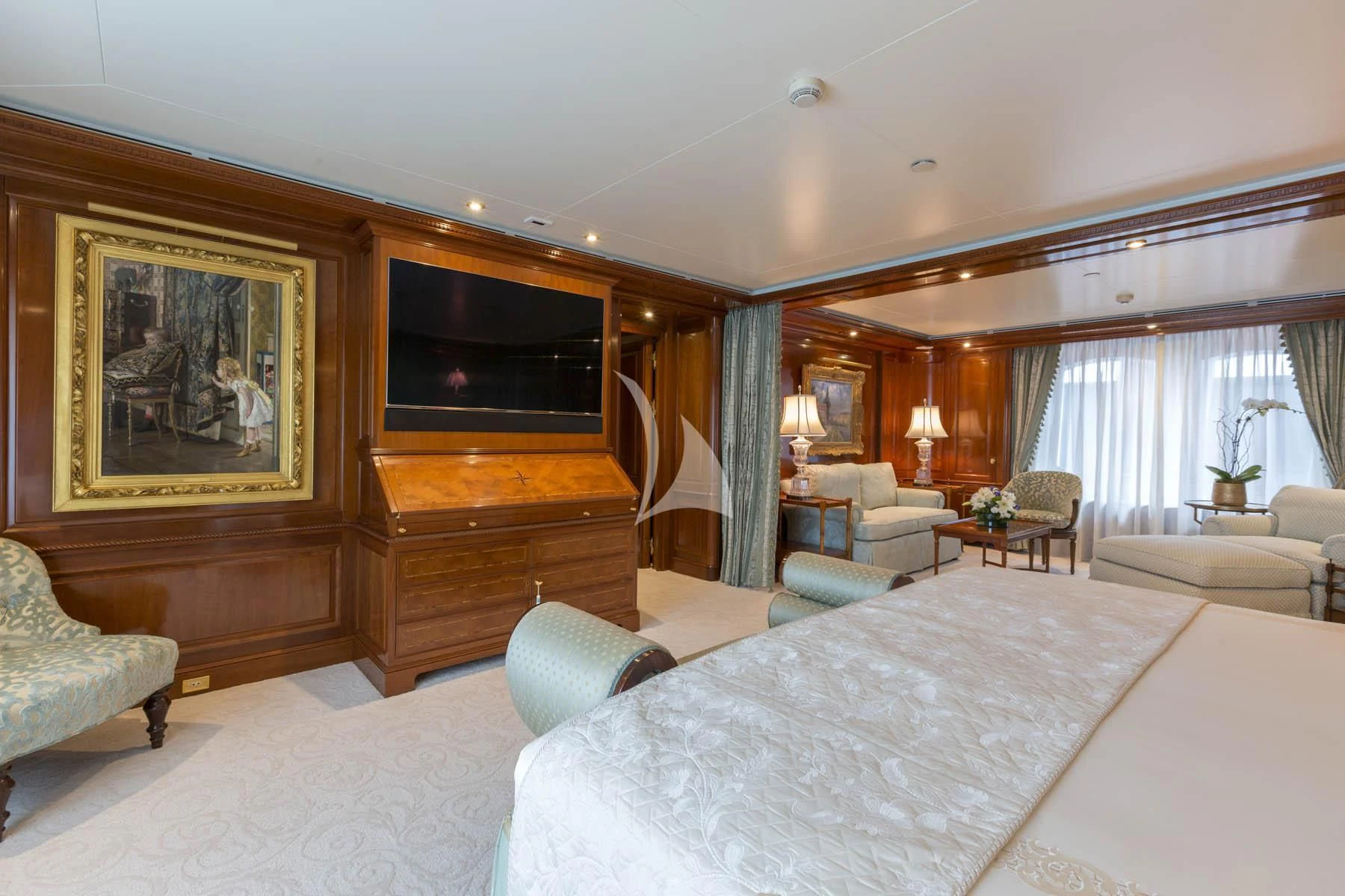 a bedroom with a large bed and a tv aboard KATHARINE Yacht for Sale