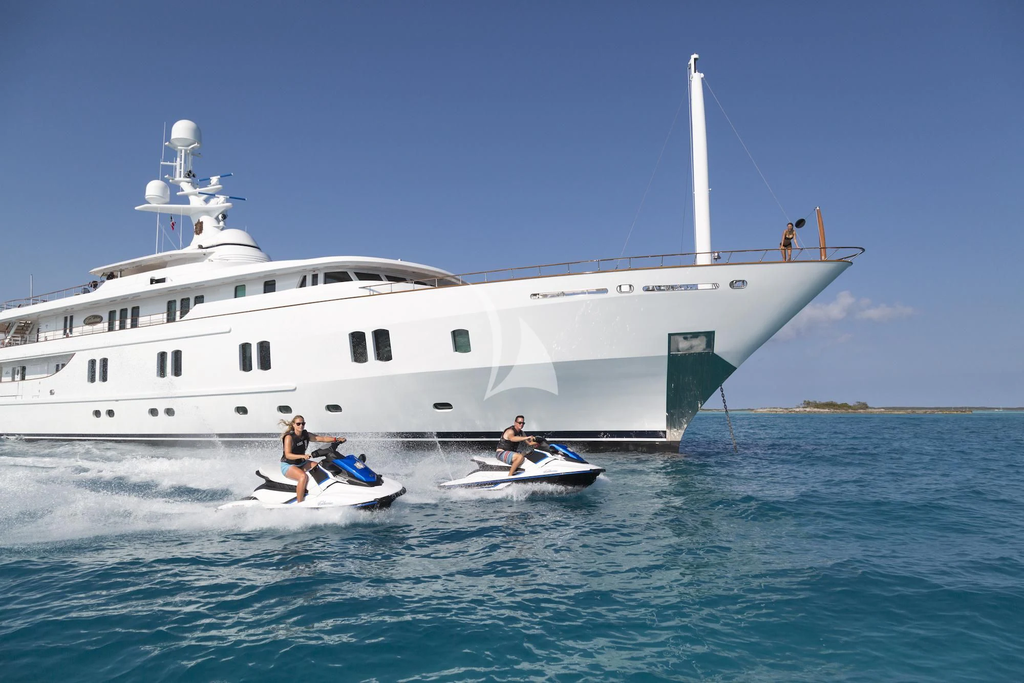 a couple of people on a boat in the water by a large white boat aboard KATHARINE Yacht for Sale